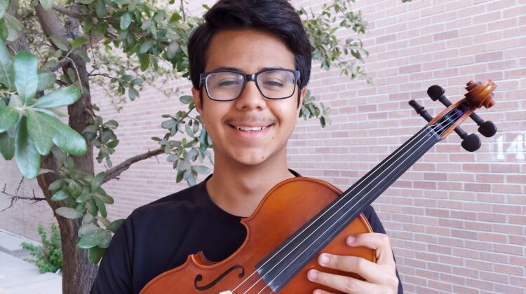 Young man holding a violin
